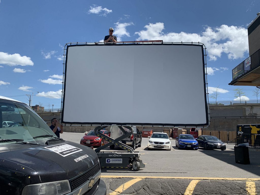 Setting up a pop up projector and screen to celebrate the NBA finals