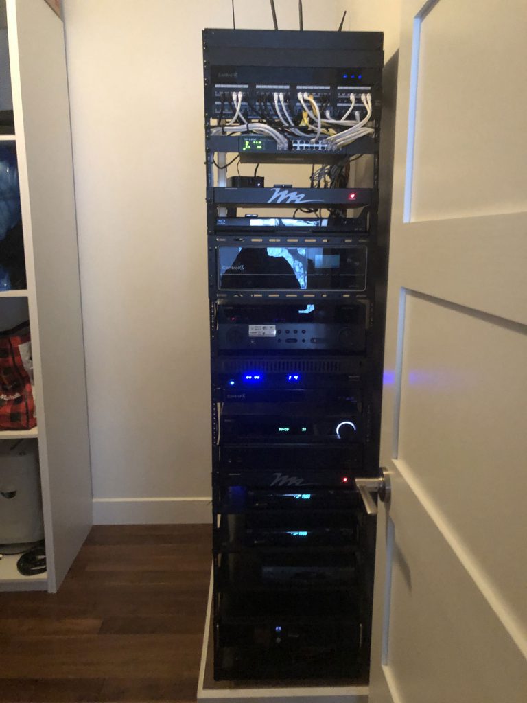 Centralized audio video and networking installation with full size rack controlled by Control4
